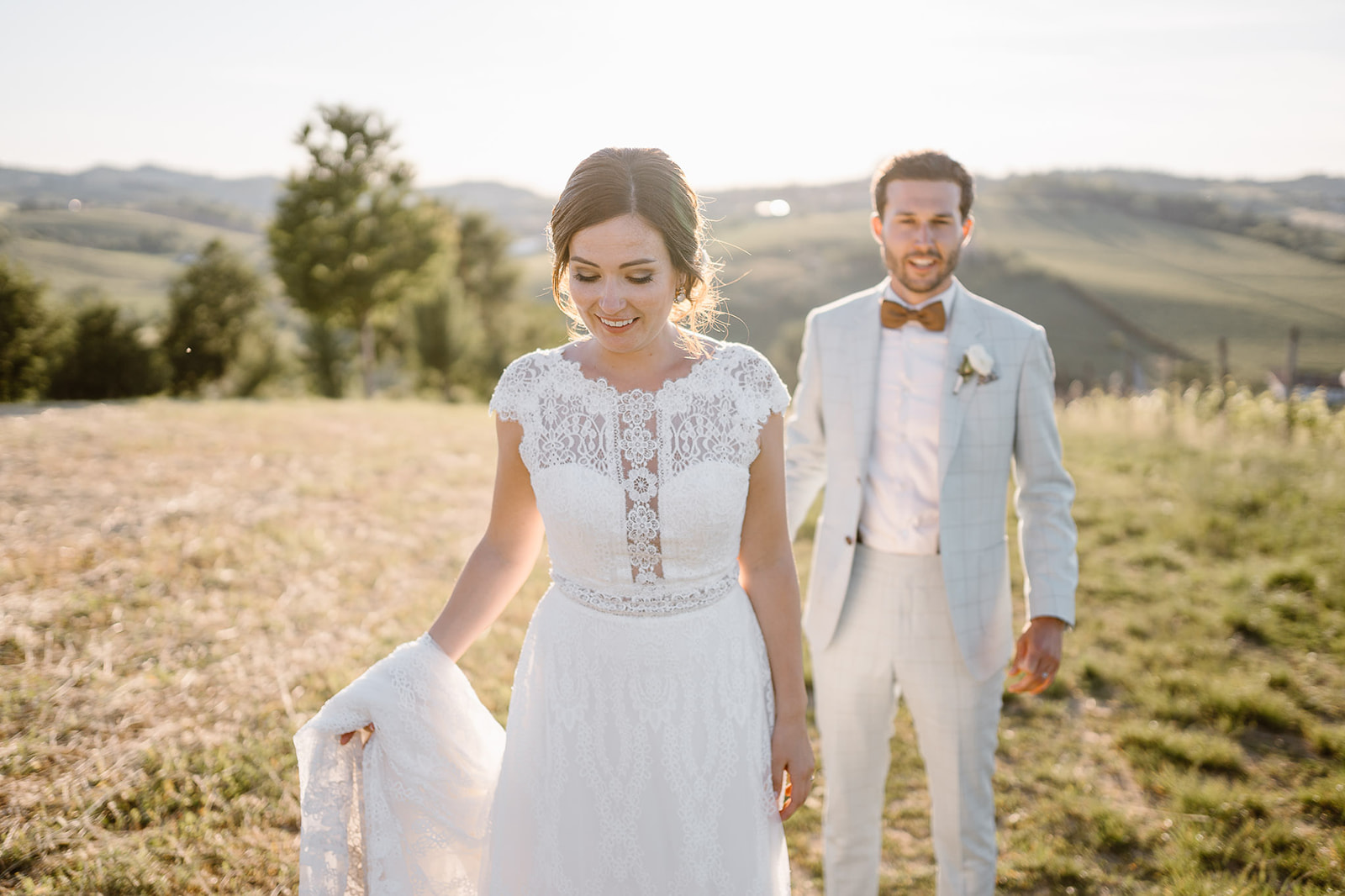 bride and groom taking photos together on a hilltop in the Italian countryside