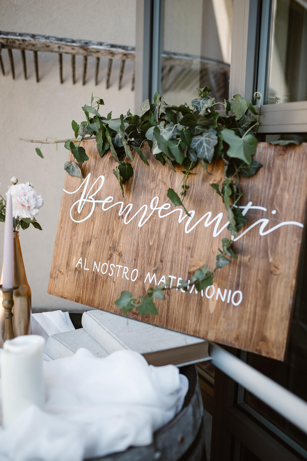 Welcome board at a wedding on a wood panel with white chalk