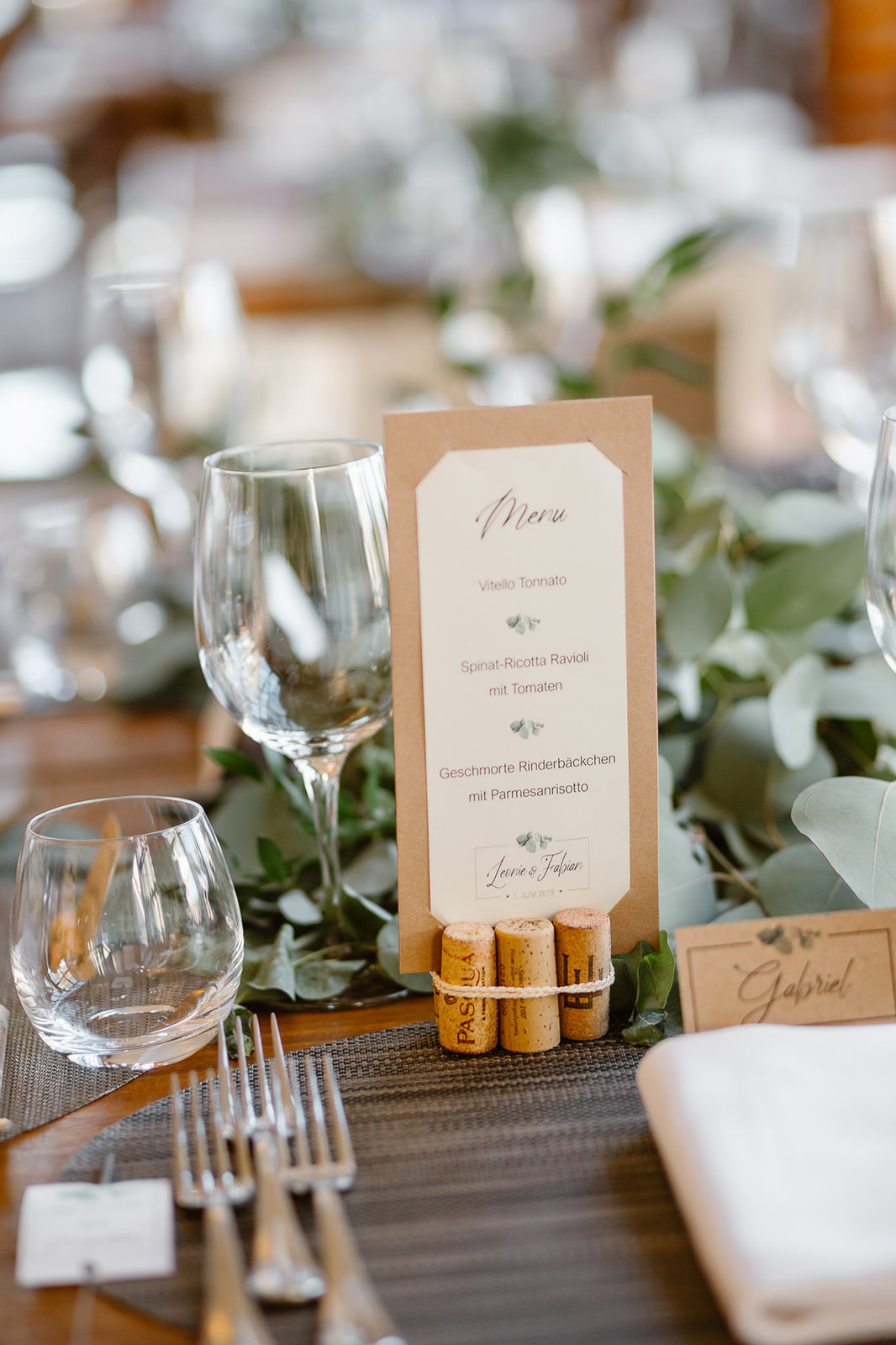 detail of a wedding table decor with eucalypt leaves and corks
