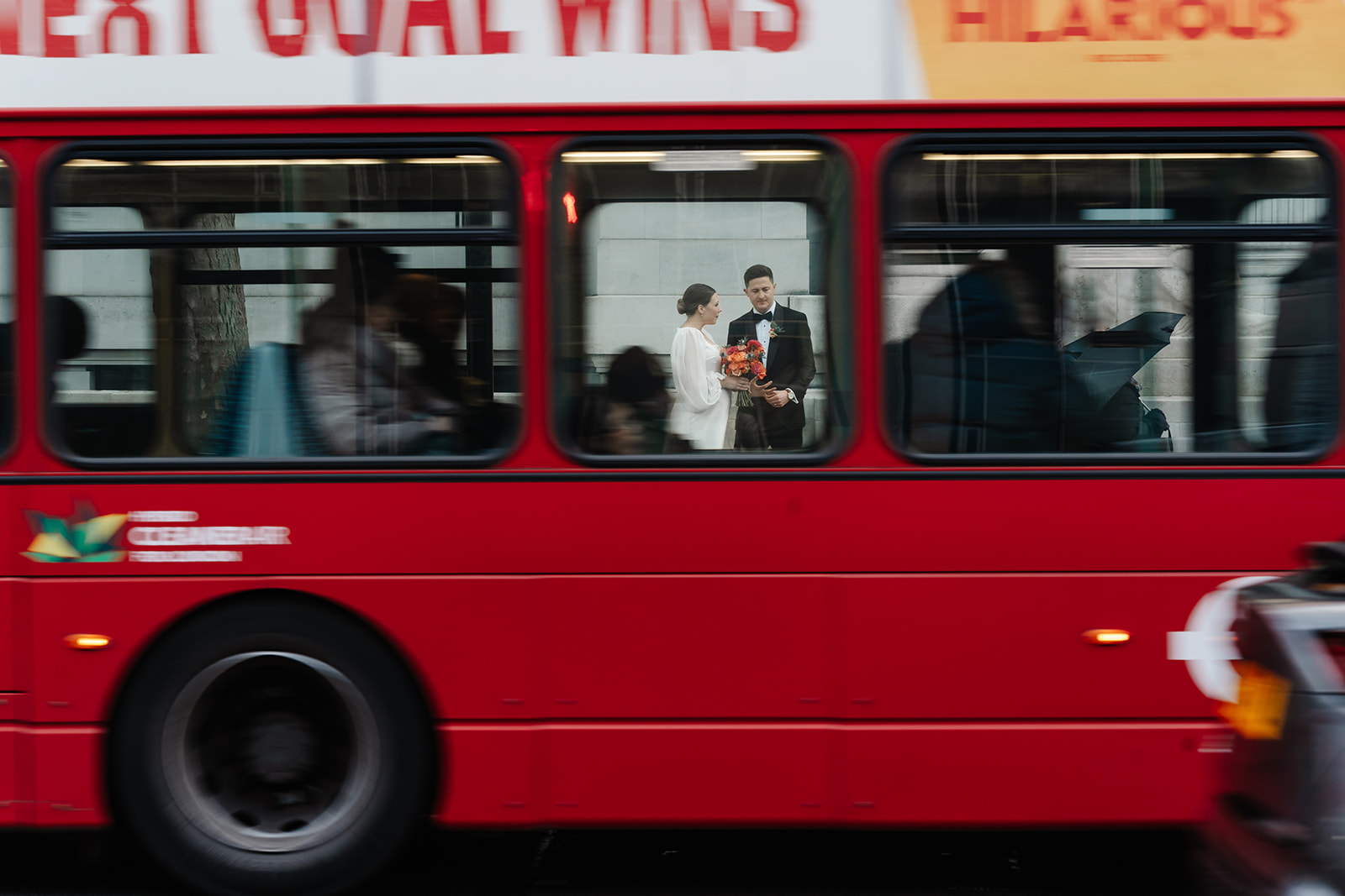 London Wedding photo capturing couple through moving bus