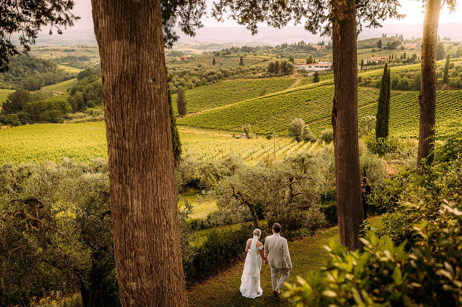 couple walking through vinyard in Tuscany