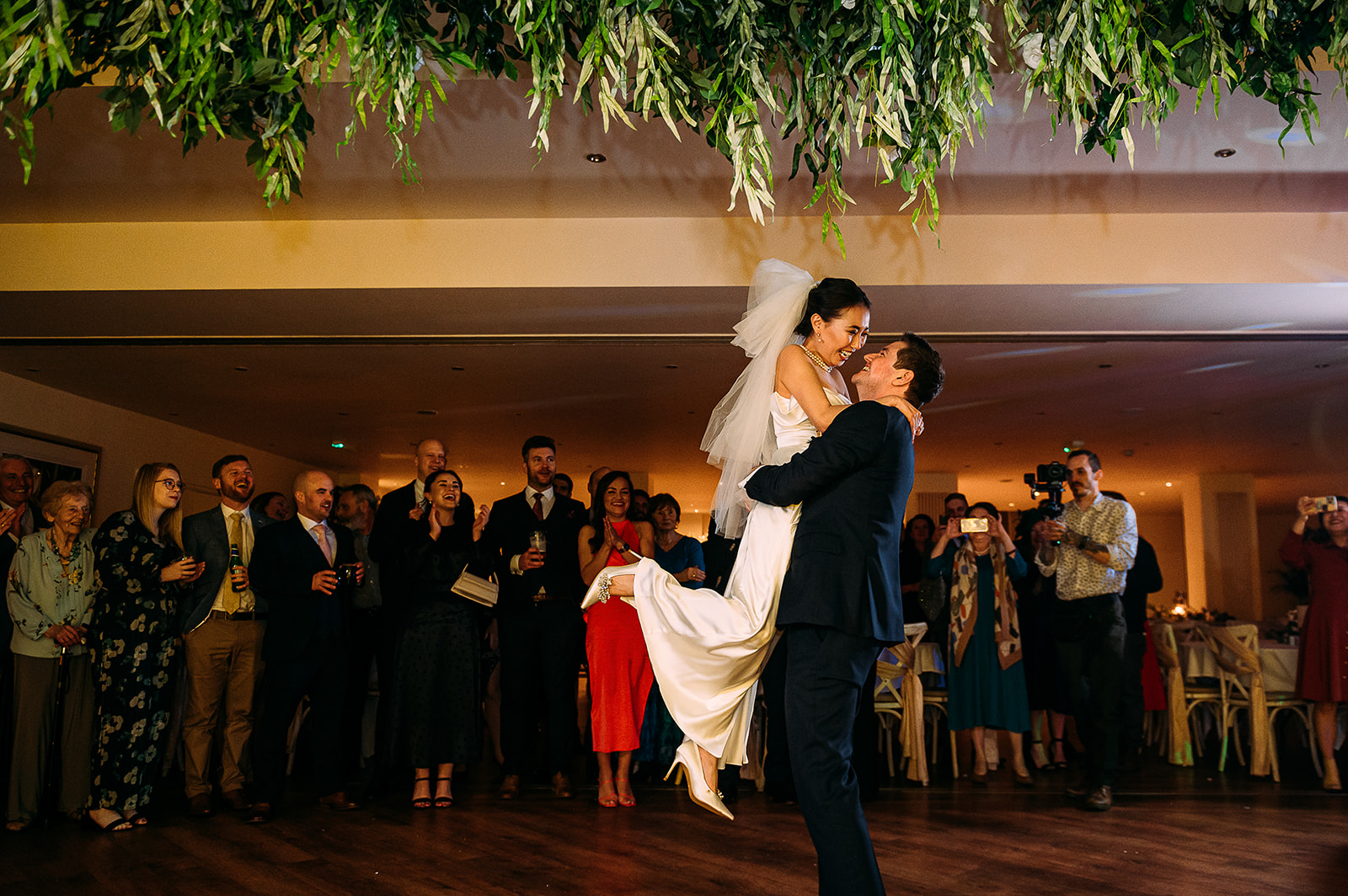 Groom lifts his bride during their first dance.