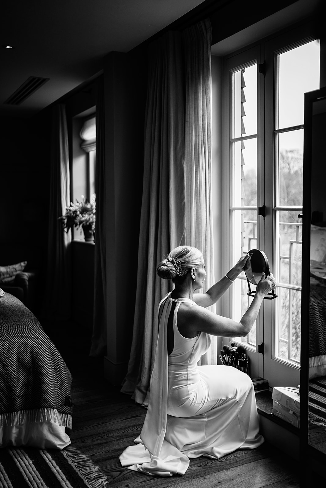 Bride applying own make-up Heckfield place