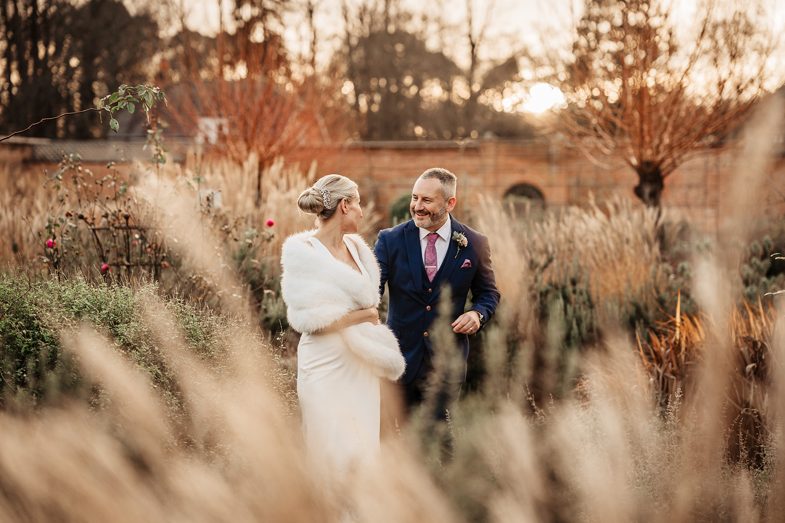 bride and groom in walled garden at Heckfield Place
