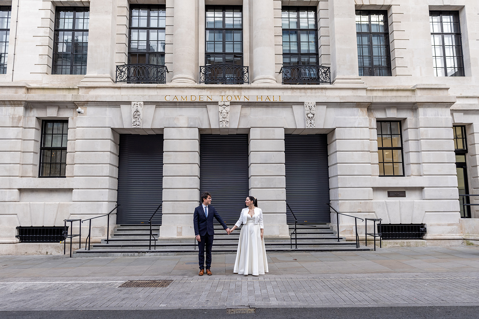 Bride and groom in front of Camden Town Hall