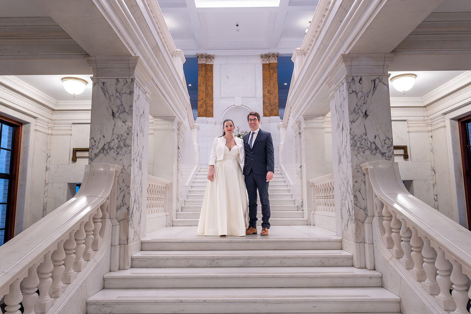 Bride and groom on staircase at Camden Town Hall