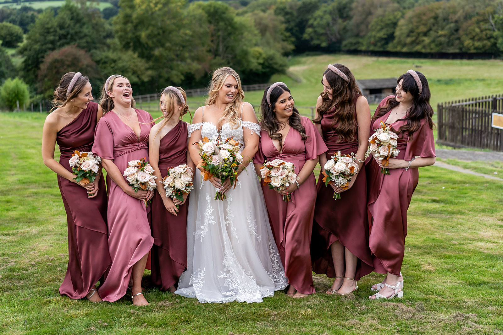 Bride and her bridesmaids all laughing and smiling