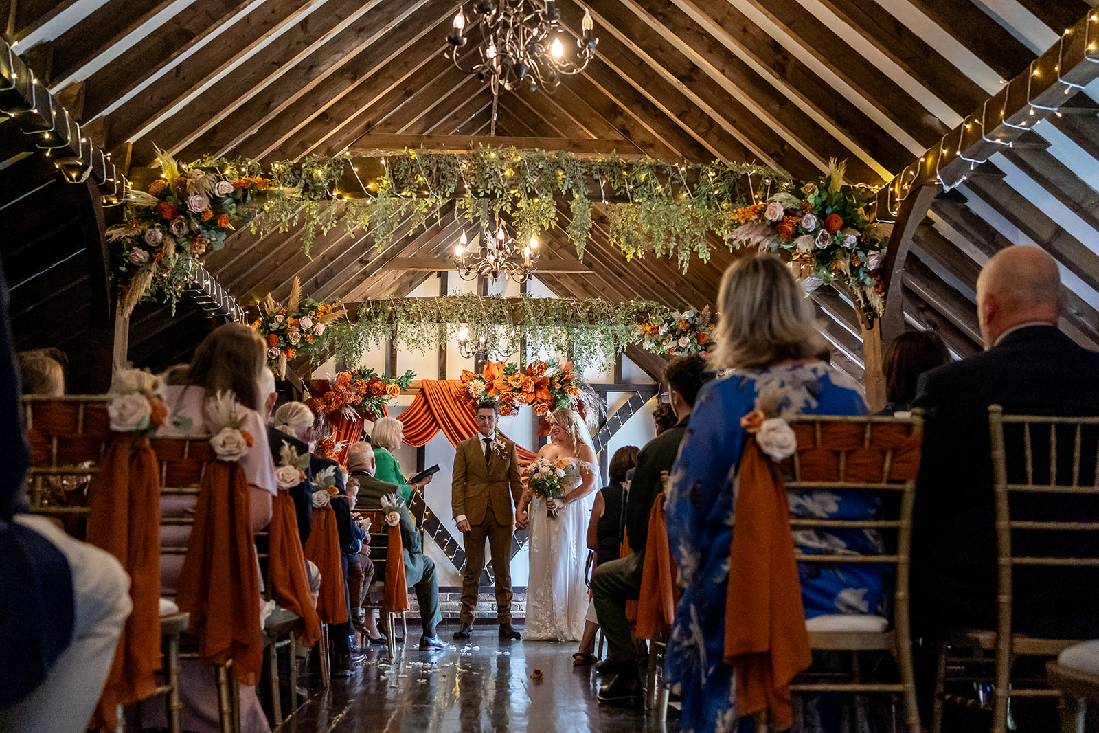 Guests watching bride and groom get married in the Tudor Barn at Blackstock Country Estate