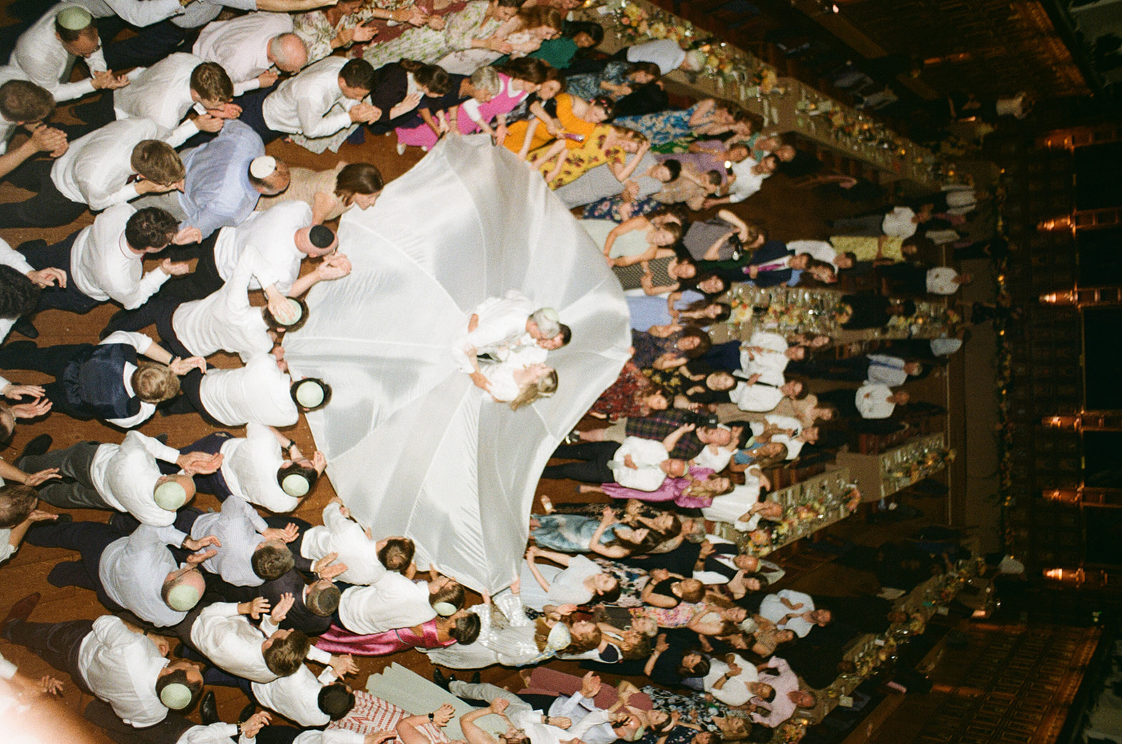 Traditional Jewish wedding dance where couple are in the middle of large white sheet