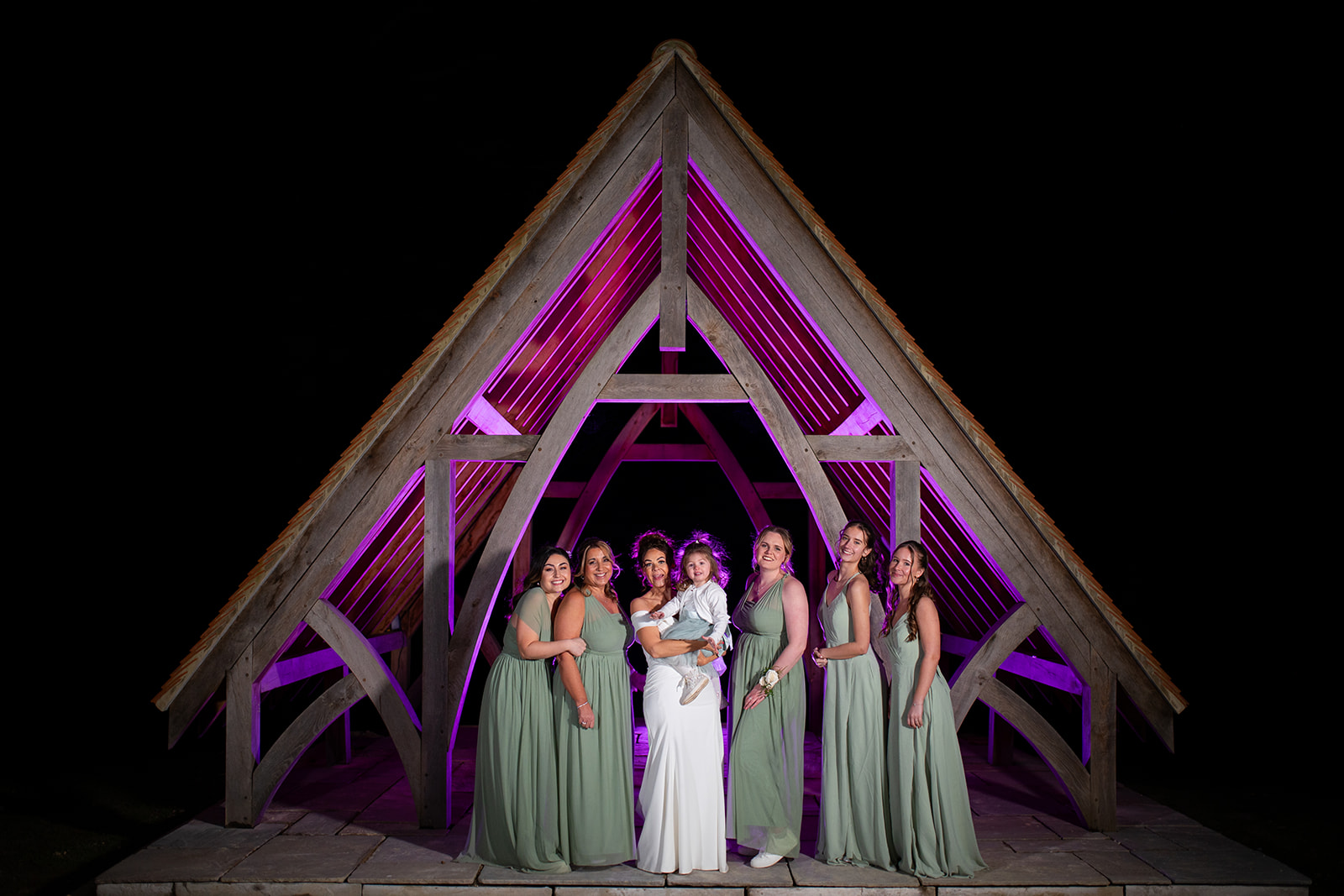bride and bridesmaids portrait under the pavilion at highley manor sussex