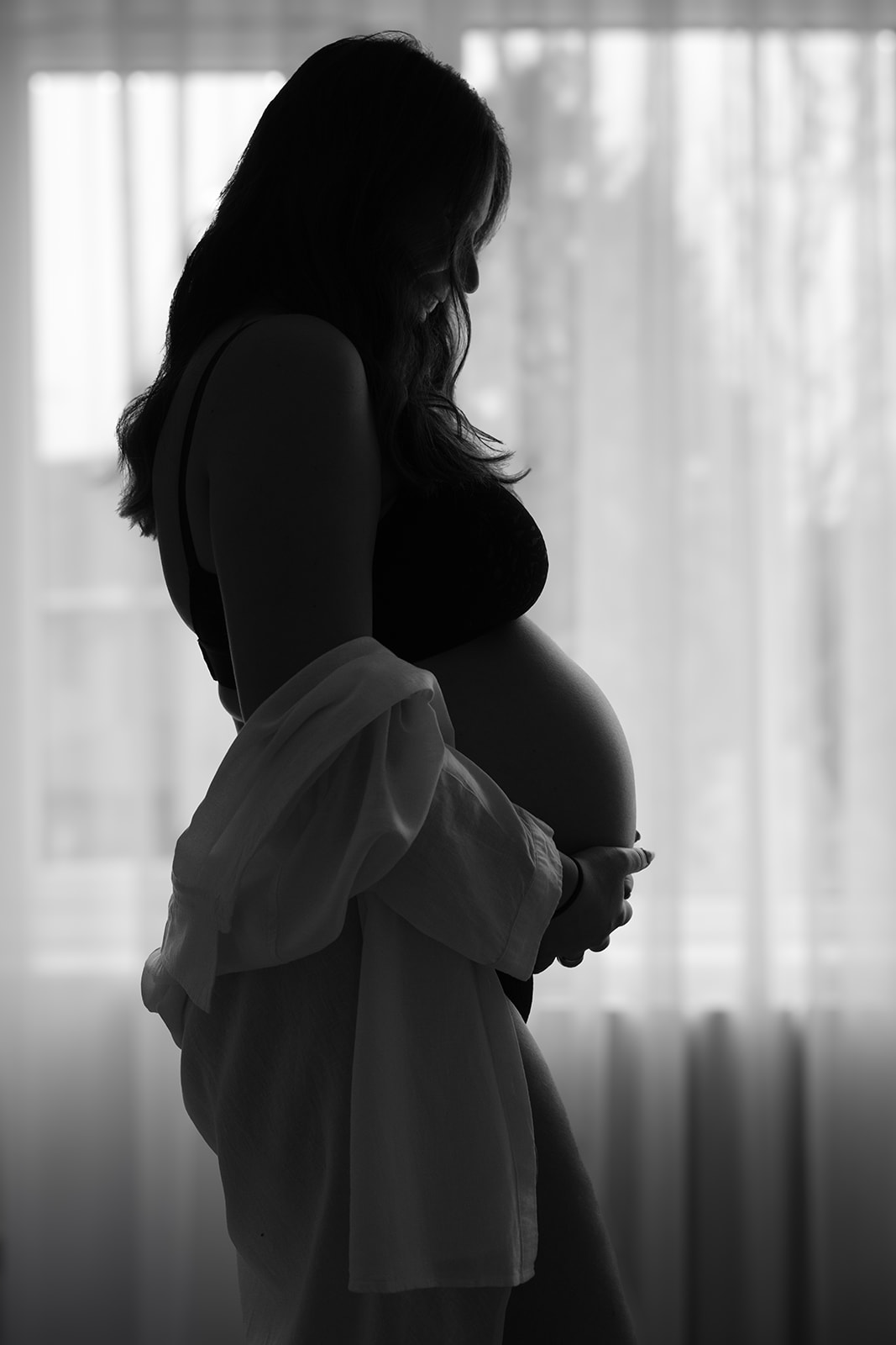 Softly lit black and white maternity home portrait