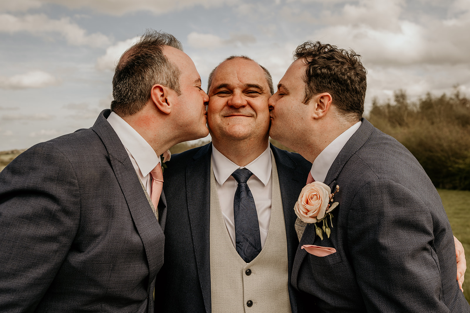 grooms kissing on wedding day