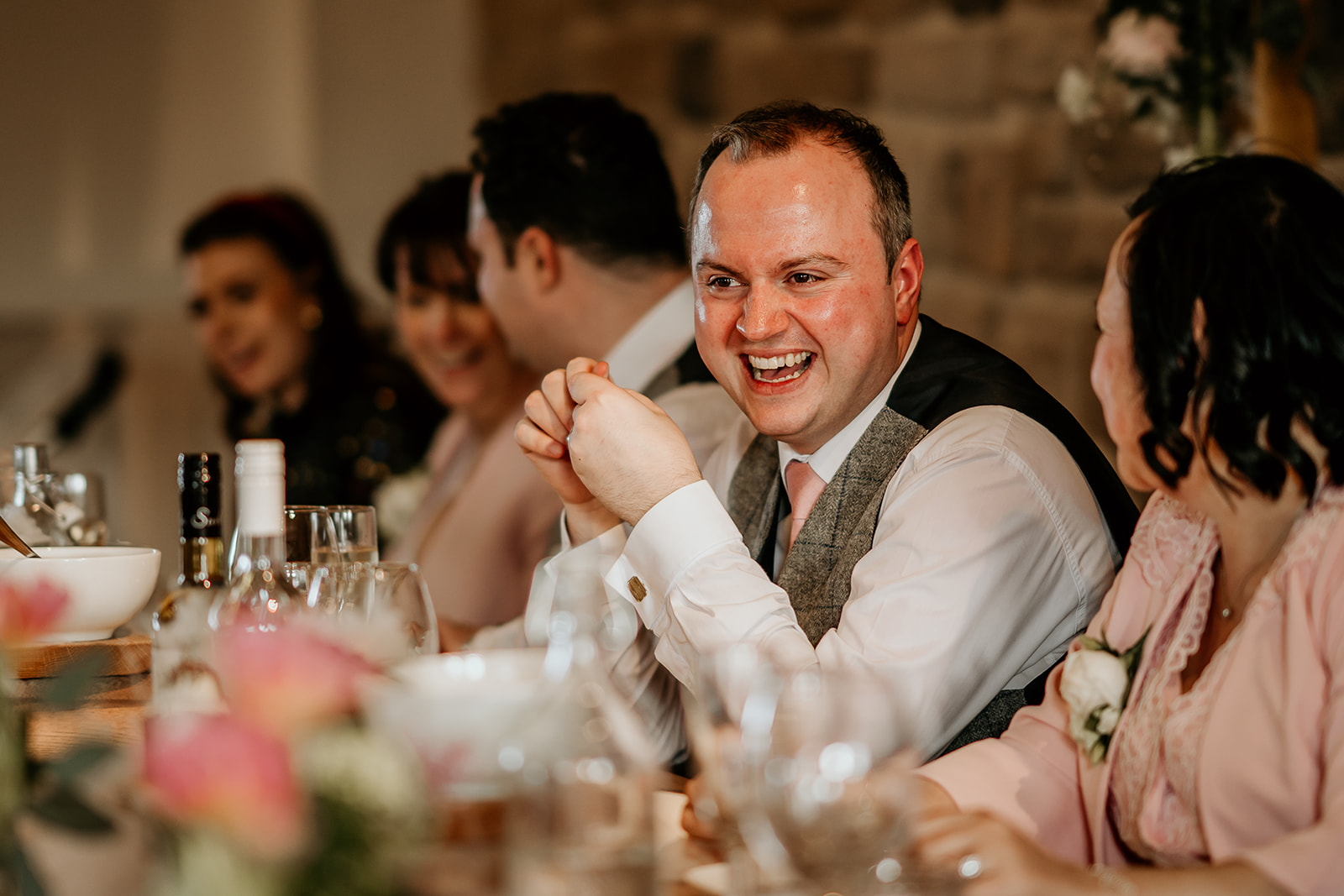 laughing at speeches on wedding day