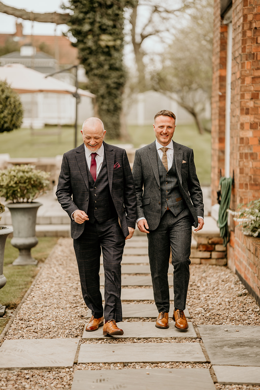 groom walking with father in wedding suit