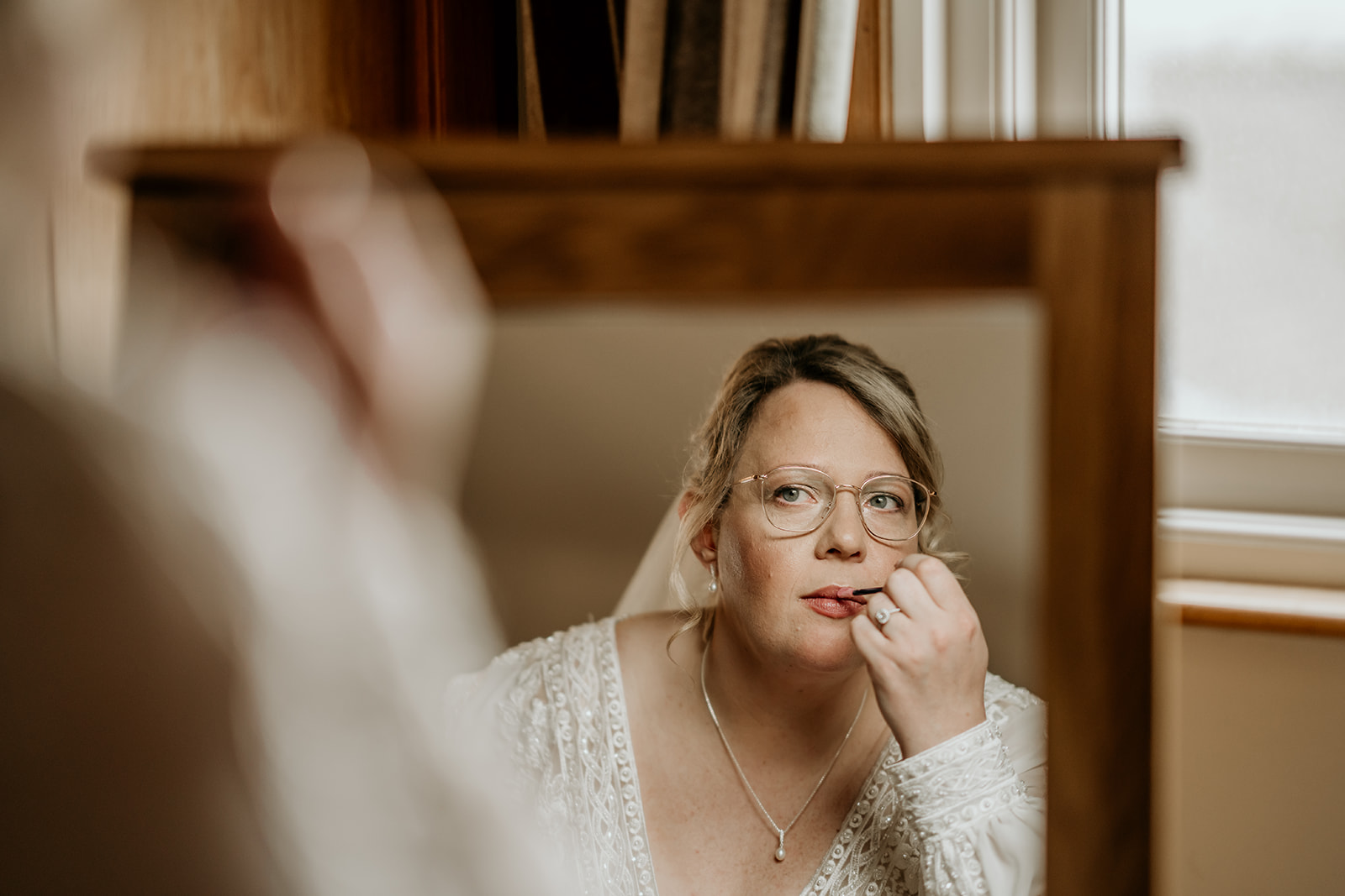 bride applying makeup at swancar farm wedding venue